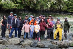 The clam garden restoration crew after a gumboots on the ground morning rock hauling and raking the hiłhuuʔis clam garden.
