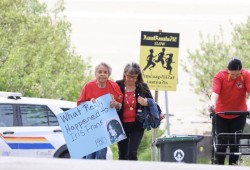 Elder Dora Frank (yaawa) walks with Anna Masso during a memorial walk for missing and murdered Indigenous people in Tofino on May 9, 2025. They wants to know what really happened to Dora’s sister Iris Frank, who was found dead by the Somass River weeks after she went missing in 1980. (Nora O’Malley photo)
