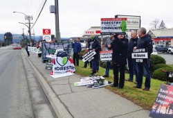 Forestry workers and their supporters protest harvesting restrictions outside the office of MLA Josie Osborne in Port Alberni on Dec. 6, 2021. (Holly Stocking photo) 