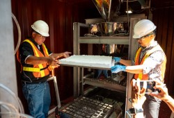 Reg Ogen and Dr. Yeling Zhu remove a freshly pressed block of wood foam at DicinFoam's Vancouver pilot plant. (Clare Kiernan/UBC photo)