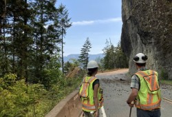 The 2023 Cameron Bluffs fire caused extensive damage to the cliffs over Cameron Lake, and stability work continues to this day, with highway delays in January 2026 to remove debris from heavy rain. (Ministry of Transportation photo)