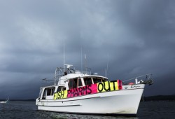 Boaters and kayakers gathered in the Tofino harbour to protest against fish farms.