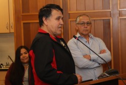 Yuułuʔiłʔatḥ First Nation President Chuck McCarthy speaks next to Legislative Member Alan McCarthy at the ACRD main office in Port Alberni, marking a decade since the First Nation joined the regional district.