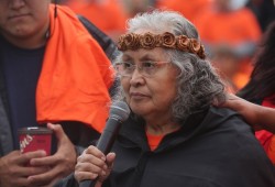 Donna Samuel, who grew up Gitxsan before marrying into an Ahousaht family, speaks in her ancestral language outside the Tseshaht Longhouse.