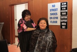 Hairdresser Doreen Little prepares Samantha Fregin for a trim at the Uchucklesaht career fair March 28.