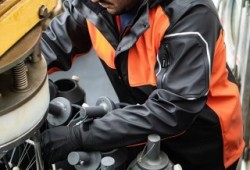 Expedition member Josh Watts prepares a rosette bottle for deep sea water samples.