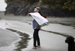 Leah Morgan practices a yoga class led by Heidi MacPherson on Opitsaht Beach for National Indigenous Peoples Day, on June 21, 2022.
