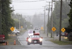 Trinity Clark is driven through the streets of Ucluelet as part of a high school graduation procession, on Saturday.