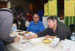 Irine Robinson, a wellness outreach worker with Teechuktl Mental Health, answers questions at the career fair, as CHS training coordinator Stan Matthew awaits other inquiries for information.