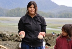 Addison Harry displays clams from the garden.