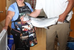 Audrey Smith and David Keim pose with salmon to be barbequed.