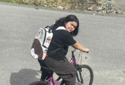 Carol Etta Bruce rides a bike the 13-year-old recently received from a donation to her community.