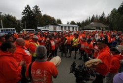 Tseshaht members led a crowd in song by Maht Mahs, as the former Caldwell Hall (back right) stood in the distance.