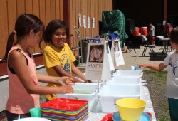 Children wash dishes after a meal during the games in Kyuquot.
