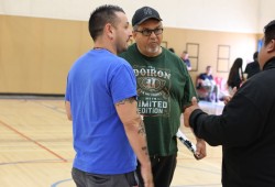 Ahousaht Guardians coach Luke Swan Jr., bottom right, gives NTC vice president Les Doiron, centre, two thumbs up after hearing the news that the 2025 Tlu-piich Games were over and everyone should journey home.