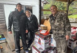 Dan Greene (left), Heather Rayand Roger Bain stand with generators and other supplies the Makah donated to the Ditidaht First Nation to help with an ongoing power outage. (Submitted photo)