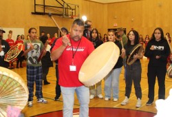 Nasimius, Ed Ross, sings with Tseshaht members at the ADSS gym on Oct. 3.