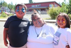 Cecilia Jackson, centre, embrace her grandkids Caiden and Charlotte at the Aug. 27 Family Fun Day in Ty-Histanis.