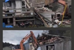 On April 29, social media live feeds lit up as videos appeared showing the demolition of two side-by-side houses in Skidegate. (Facebook photo)