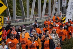 A crowd crosses the Somass River bridge to the former site of the Alberni Indian Residential School as part of an Orange Shirt Day event on Sept. 30. (Karly Blats photo)
