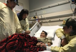 Brother Eli Billy (left), sister Samantha Billy and oldest son Russell comfort Darlene Smith at Vancouver General Hospital on Dec. 3. (Eric Plummer photo)