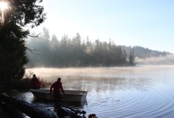 Parks Canada staff work on Cheewaht Lake in Ditidaht First Nation territory in 2022.