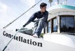 James Martin repositions his brother's boat so that he can paint its sides more easily, in Ucluelet, on July 15, 2020. (Melissa Renwick photo)
