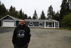 Tseshaht Chief Councillor Ken Watts stands by a 1,863 square-foot house on a recently purchased property. The home will be available for members to rent. (Eric Plummer photo)