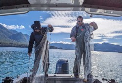Judae Smith and Rob John prepare cast nets as herring spawn in Nootka Sound. (Claudia Tersigni photo)