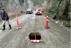 On the morning of Feb. 10, 2024 a hole large enough for a person to fall into was found on the road to Nitinaht. Within four hours a crew from the Ditidaht First Nation has stabilized the road enough for a single-lane passage, but just over a month later an even wider hole opened on the road on March 24. (David Daryl Tate photos)
