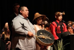 Noah Thomas sings a song he composed, accompanied by his daughter Kiana Tom and Ei-Ra Charleson. (Eric Plummer photo)