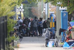 A crowd gathers in front of a supervised consumption site on Pandora Avenue in Victoria. (Eric Plummer photo)