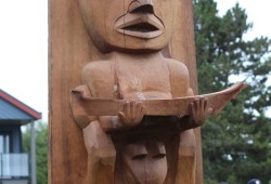 The thunderbird rests on a whale, under which sits a human, representing the late Tla-o-qui-aht hereditary chief Ray Seitcher. 