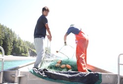 Marques (left) and Garrett Edgar pull a net out of the water where the Nitinaht Narrows meet the open sea.