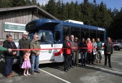  Charles McCarthy, president of the Yuułuʔiłʔatḥ Government, cuts a ribbon marking the introduction of the West Coast Transit bus service.
