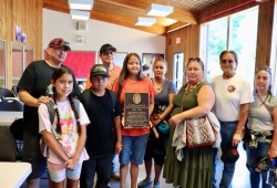 The family of late chief councillor Richard Lucas hold the plaque that will hang in the powerhouse.