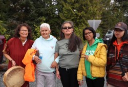 Residential School warrior Rose Tom, second from the left, arrives at Tin Wis after walking with friends and family the 3.6-kilometre distance from Tofino. 