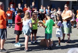 E.J. Dunn students and faculty sing the school district's song, našukʔaƛin. (Alexandra Mehl photo)