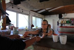 Shelley Edgar serves breakfast to hikers at the Nitinaht Crabshack.