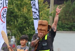 Saya Masso holds a carved mask during the Tla-o-qui-aht parade.