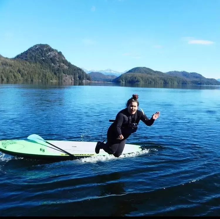 Natasha Charleson stand-up paddle boards in Grice Bay, near Tofino, as part of the Indigenous Ecotourism Training Program. (Photo suppled by Natasha Charleson)