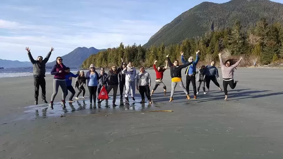 Natasha Charleson jumps with her cohort on Meares Island during the Indigenous Ecotourism Training Program. (Photo suppled by Natasha Charleson)