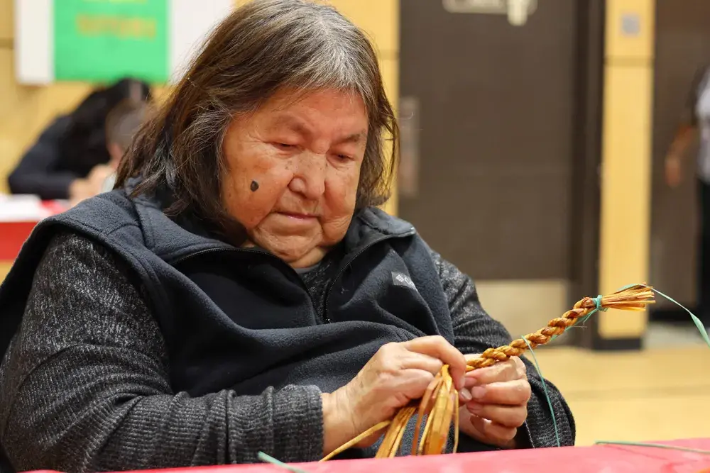 While working on a cedar weaving project, Betty Nicolaye said she hopes for “peace, good health and success for all the young people.”