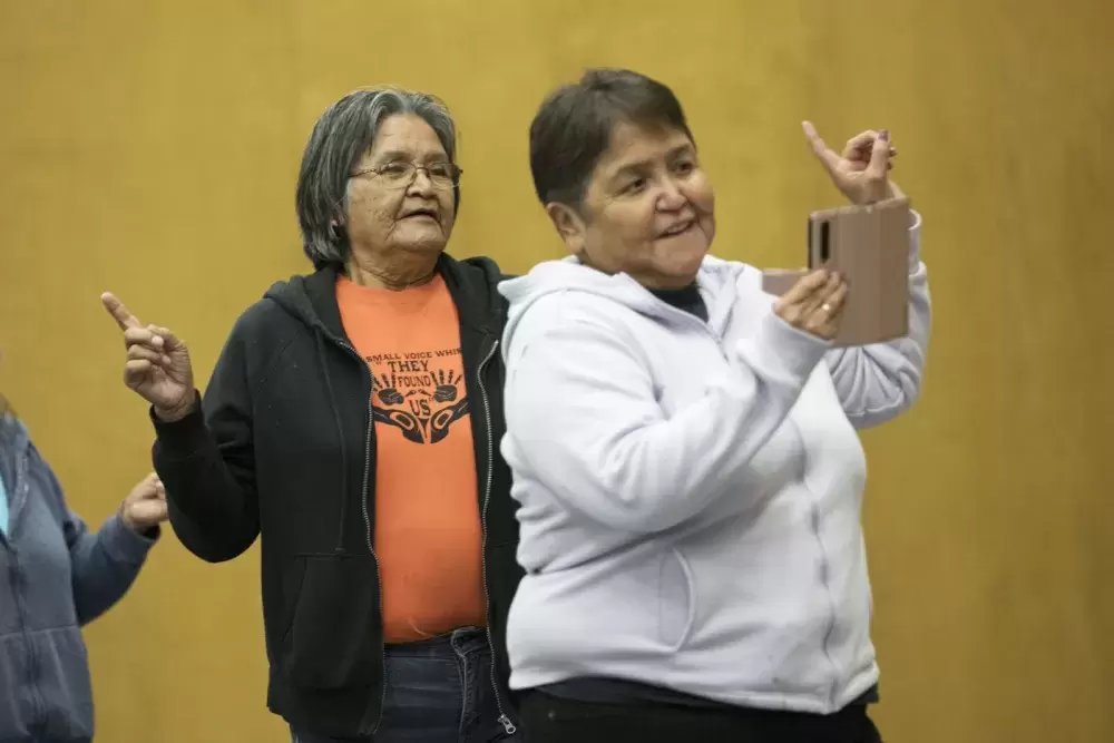 Women dance in celebration after the announcement of the new funding for a bighouse in Maaqtusiis Secondary on Flores Island, British Columbia, on August 10, 2022.