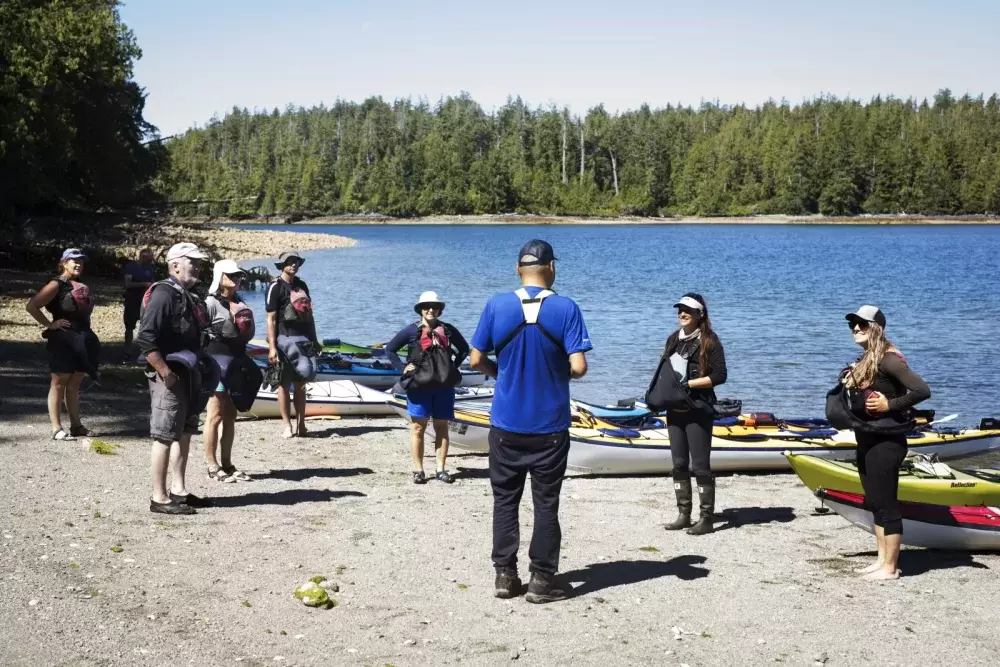 Hank Gus tells the Tseshaht First Nation creation story to a group of kayakers on Gibraltar Island, in the Broken Group Islands, in Barkley Sound.