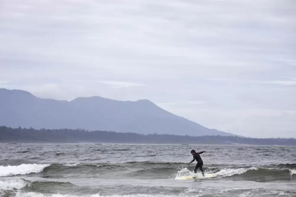 Ali Swan, 9, rides a wave in front of Esowista, near Tofino, on June 14, 2021.