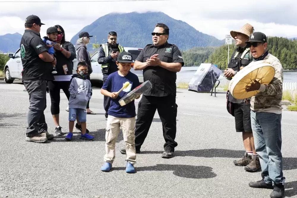 Tla-o-qui-aht Tribal Parks guardians joined to sing and drum in front of business storefronts in Tofino as a thanks for becoming a Tribal Parks ally, on June 9, 2021.