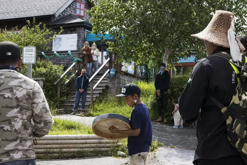 Tla-o-qui-aht Tribal Parks guardians joined to sing and drum in front of business storefronts in Tofino as a thanks for becoming a Tribal Parks ally, on June 9, 2021.