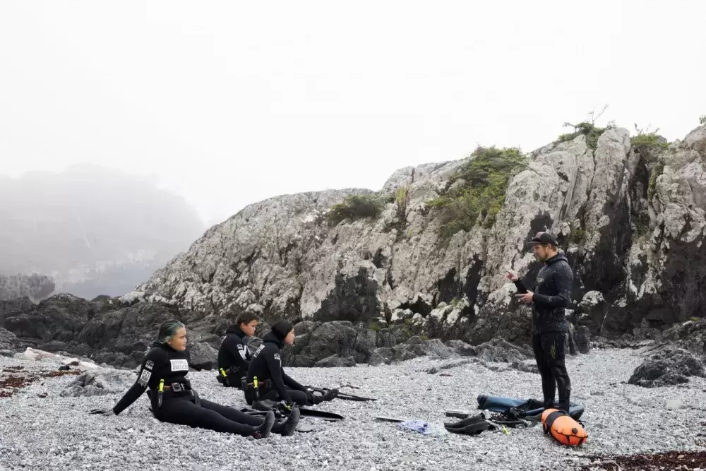 Chris Adair, owner of Bottom Dwellers Freediving, provides safety instructors before the Tseshaht youth enter the ocean, along the Wild Pacific Trail, in Ucluelet, on August 18, 2021.
