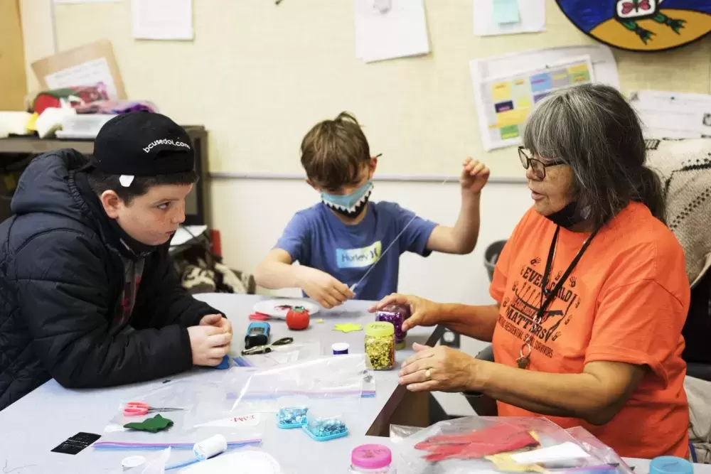 Grace George helps Grade 3-4 students with their art projects at the Wickaninnish Community School, in Tofino, on November 22, 2021.